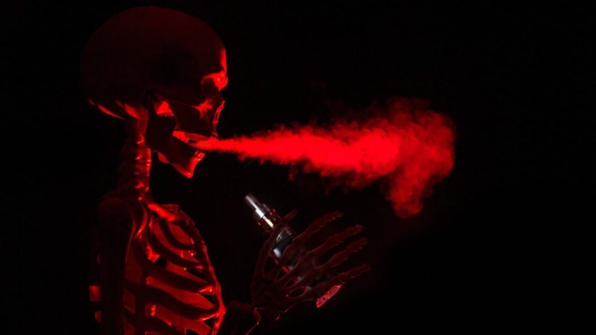 Stylised skeleton exhaling red vapour, illustrating how nicotine travels through the body